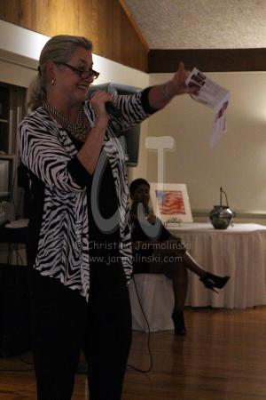 Ginny, auctioneer on this evening and board member of AI&G