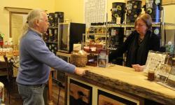 Rob discussing the various olive oils with Sophika sold in the Corner Shoppe  by Christina Jarmolinski