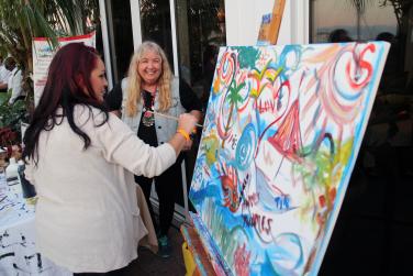 Christina Jarmolinski, artist, with one of the passer-bys at the party